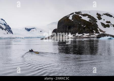 Danco Island, Antarctic Peninsula - January 31, 2024. Crew members of an Antarctic expedition ship prepare canoes and zodiac for excursions in the Antarctic waters near Danco Island Stock Photo