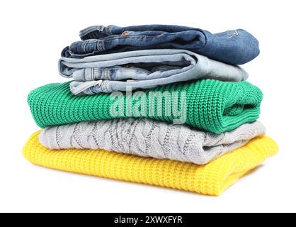 Stack of sweaters and jeans isolated on white Stock Photo