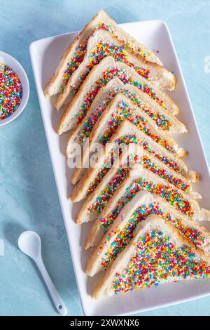 Slices of fairy bread on a plate. Fairy bread is a traditional Australian party food Stock Photo