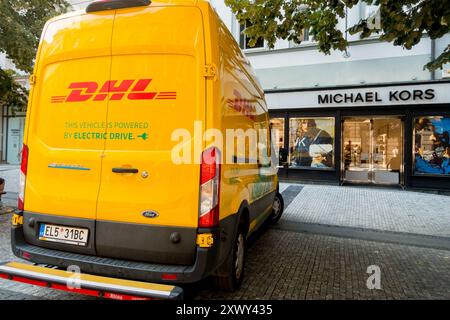 DHL Van Delivery Service in front of Michael Kors Luxury Shop Store, Na Prikope Street, Prague Czech Republic Stock Photo