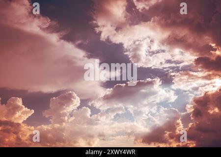 Toned Pink-yellow Clouds. Toned Cumulus Clouds Float In Blue Sky. Saturated Yellow Colors Of Clouds. . Unusual Sky Background. Rich Colors Pink Colors Stock Photo