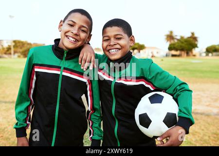 Happy children, portrait and hug with soccer team or ball in sports, match or game together on grass field or pitch. Young friends, athlete or Stock Photo