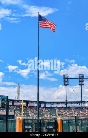 Detroit, USA - August 1, 2024: The American flag waving on a blue sky in the Comerica Park Stock Photo