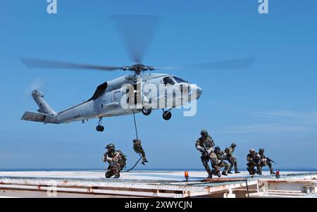 Navy SEAL (SEa Air Land) operators practice on domestic Gas and Oil Platforms (GOPLAT) to prepare for future attacks on world oil production facilities. Navy SEALs are maritime special operations forces who strike from the SEa, Air and Land.  They operate in small numbers, infiltrating their objective areas by fixed-wing aircraft, helicopters, Navy surface ships, combatant craft and various underwater crafts.  SEALs have the ability to conduct a variety of high-risk missions- unconventional warfare, direct action, intelligence gathering, special reconnaissance, combat search and rescue, divers Stock Photo