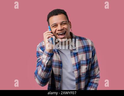 Smiling Positive Man Talking By Phone, Smiling. Mature Guy On pink Background. Stock Photo