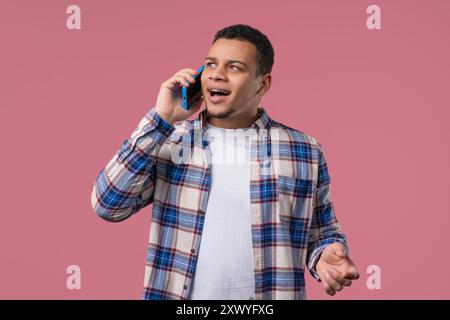 Smiling Positive Man Talking By Phone, Smiling. Mature Guy On pink Background. Stock Photo