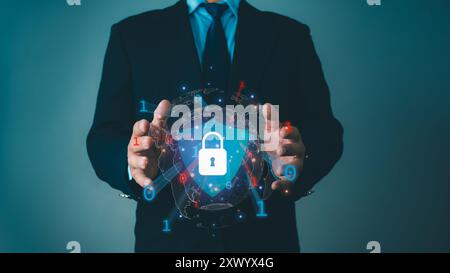 Businessman protecting data personal information on virtual interface, Network security system concept, Locked key inside a shield guard to protect pe Stock Photo