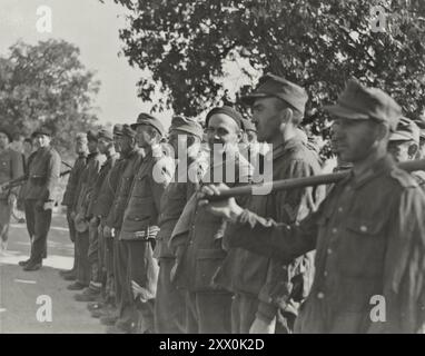 World War II. Once They Were The Captors, Now They Are The Captives - These German Prisoners Are Ready To Go To Work On A French Airfield From Which American Airmen And British Empire Troops Will Be Put On Planes To Take Them Back Home After Being Captured And Escapin. October 1945 Stock Photo