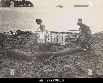 World War II. Landings on Rendova. Part of the New Georgia campaign. June - July 1943. Marines from a defense battalion carrying a wounded buddy from a height finder position after he was hurt by flying coral during a Japanese dive bomber raid. The only casualty, Cpl. James E. Burns, USMC, of Bethel, Conn. (on the stretcher). Stock Photo