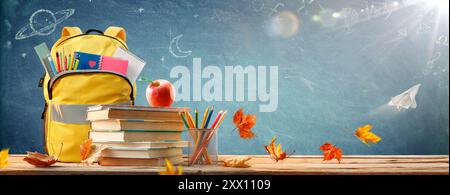 Back To School - Schoolbag And Books With Pencils And Stationary On Blackboard Stock Photo
