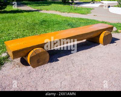 Garden bench made of sawn logs in half Stock Photo