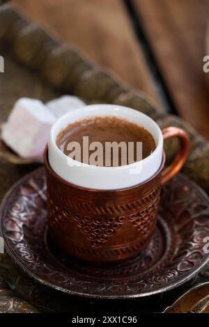 traditional turkish coffee in copper cup in close up on table Stock Photo