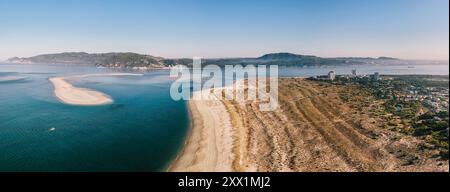 Aerial drone panoramic view of Troia, a peninsula located in Grandola Municipality, next to Sado River estuary, with Arrabida mountain range Stock Photo