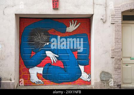 Painting on garage door by Ella and Pitr, street artists, Henri Gonnard street, Saint-Etienne, Loire department, Auvergne-Rhone-Alpes region, France Stock Photo