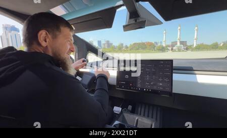 Grozny, Russia. 17 August, 2024. Chechen leader Ramzan Kadyrov, behind the wheel of a Tesla Cybertruck outfitted with a heavy machine gun mounted in the truck bed, August 17, 2024 in Grozny, Chechen Republic, Russia. Kadyrov claimed the truck was a gift from Tesla chief executive Elon Musk who denied any involvement.  Credit: Handout/Kadyrov 95/Alamy Live News Stock Photo