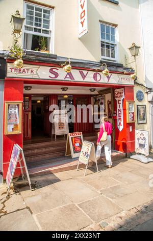 Woman about to enter the Savoy cinema and theatre in church Street, Monmouth reputedly the oldest working theatre site in Wales Stock Photo