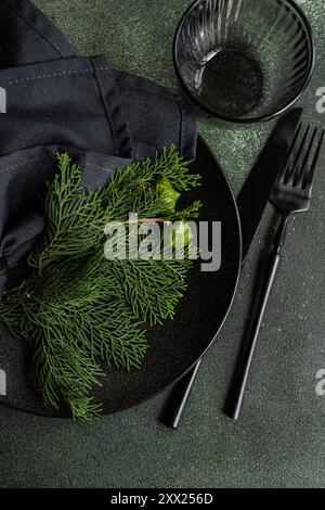 Overhead view of a Christmas place setting with fresh thujia branches Stock Photo