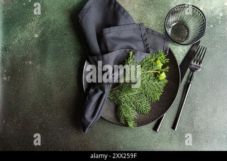 Overhead view of a Christmas place setting with fresh thujia branches Stock Photo