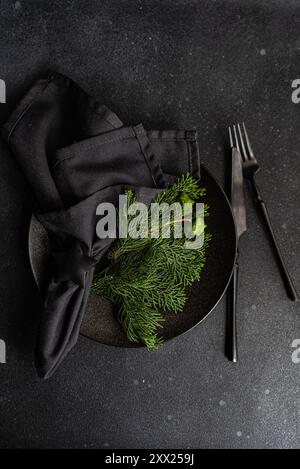 Overhead view of a Christmas place setting with fresh thujia branches Stock Photo