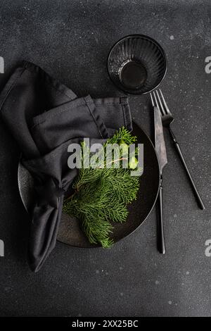 Overhead view of a Christmas place setting with fresh thujia branches Stock Photo