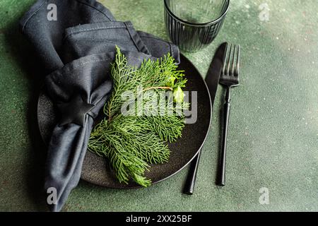 Overhead view of a Christmas place setting with fresh thujia branches Stock Photo