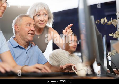 Group of older people studying on computer course Stock Photo