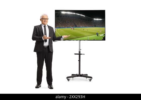 Tv host presenting in front of a tv screen isolated on white background Stock Photo