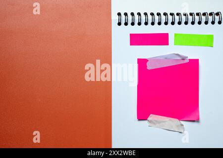 Pink and green sticky notes on a white background. The pink one is on the right and the green one is on the left Stock Photo