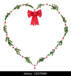 Christmas  heart wreath with fir, red bow and winter holly berries on white. Solstice symbol of love for holiday season, gift tag, invitation. Stock Photo