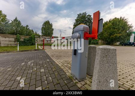 Abandoned parking barrier, empty spaces in the paid parking lot, entry to the property prohibited Stock Photo