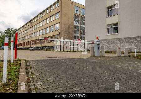 Abandoned parking barrier, empty spaces in the paid parking lot, entry to the property prohibited Stock Photo