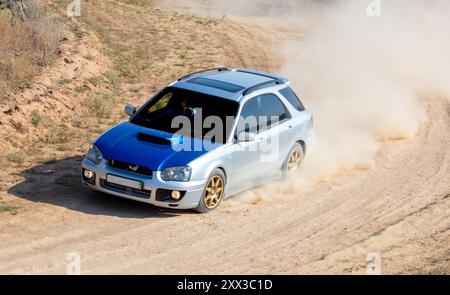 Sharpness Car Rally Sunny summer day. A sharp turn on a rally dirt track. The rally car ...