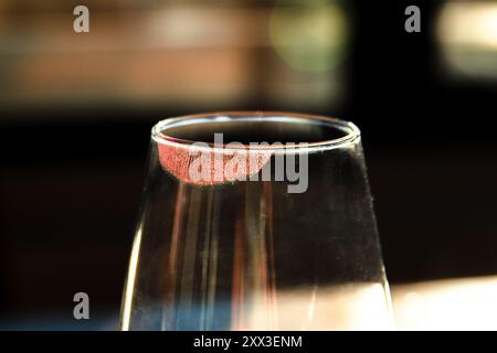 Wine glass with red lipstick print on it Stock Photo