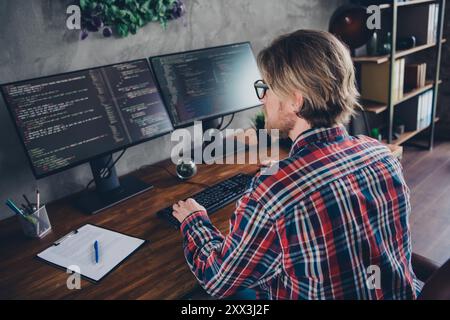 Photo of handsome young guy working computer programmer wear plaid shirt coworking successful businessman nice light office Stock Photo