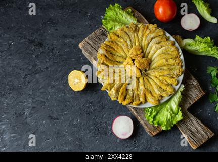 Cooked haddock fishes with cornflour in plate on rustic table Stock Photo