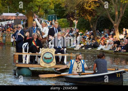 The Hop Queen of Poperinge rides on a float with other representatives from Hythe's twin town of Poperinge at the Hythe Venetian Fete. Decorated floats parade along the Royal Military Canal in Hythe Kent, UK, 21st August 2024. Stock Photo