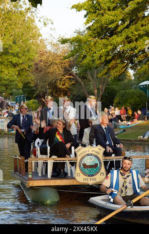 The Hop Queen of Poperinge rides on a float with other representatives from Hythe's twin town of Poperinge at the Hythe Venetian Fete. Decorated floats parade along the Royal Military Canal in Hythe Kent, UK, 21st August 2024. Stock Photo