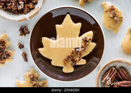 Maple pecan shortbread cookies with a large maple leaf shaped one on a plate. Stock Photo