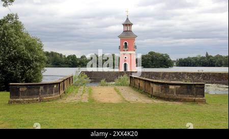 Lighthouse on the jetty, by the lake near Little Pheasant Castle, landing ramp in the foreground, view on a cloudy day, Moritzburg, Germany Stock Photo