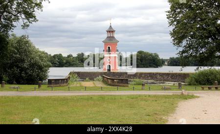 Lighthouse on the jetty, by the lake near Little Pheasant Castle, landing ramp in the foreground, view on a cloudy day, Moritzburg, Germany Stock Photo