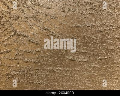 Texture of artistic plaster bronze colors. Abstract art stucco brown background with pattern, macro. Structure of umber decorative wall, backdrop clos Stock Photo