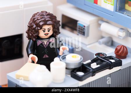 Tambov, Russian Federation - August 18, 2024 A Lego woman minfigure standing in a kitchen and frying eggs Stock Photo