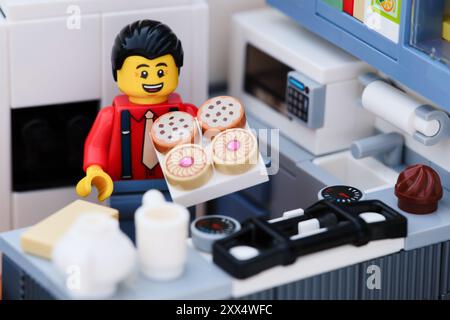 Tambov, Russian Federation - August 18, 2024 A Lego man minfigure with cookies standing in a domestic kitchen Stock Photo