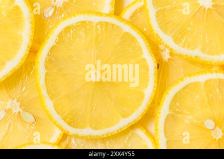 Organic Raw Yellow Sliced Lemons on a Cutting Board Stock Photo
