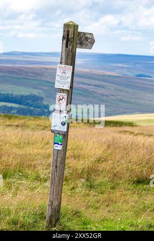 A wooden signpost showing a public bridleway to Carrshield at an altitude of 550 metres on Carrshield Moor near Coalcleugh, Northumberland, England UK Stock Photo