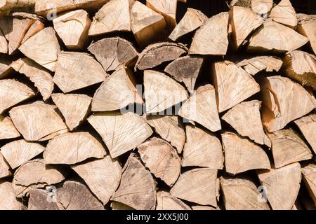 Firewood logs split and stacked for seasoning, UK renewable fuel Stock Photo