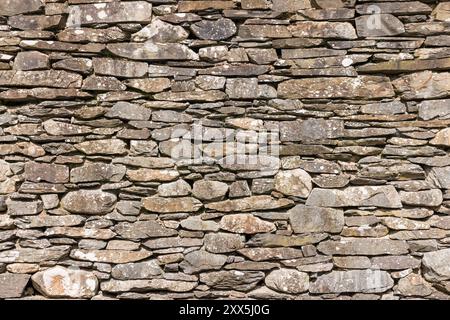 Detail of dry stone wall on an ancient building in English Lake District, UK. Full frame pattern, texture or background. Stock Photo