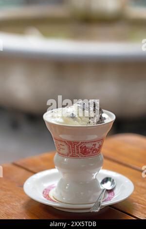 A Rudesheimer coffee served in a traditional cup and saucer. A Rudesheimer coffee is made with the local Asbach brandy and black coffee, topped with f Stock Photo