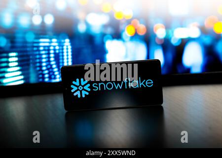In this photo illustration, the Snowflake logo is displayed on a smartphone screen. Stock Photo