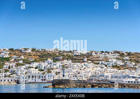 Mykonos, Greece - 7 May 2024: The town of Mykonos on the Greek island of the same name, known for its whitewashed houses and deep blue sea. View of a lighthouse in the town s old harbor *** Die Stadt Mykonos auf der gleichnamigen griechischen Insel, bekannt für ihre weiß getünchten Häuser und das tiefblaue Meer. Blick auf einen Leuchtturm im alten Hafen der Stadt Stock Photo